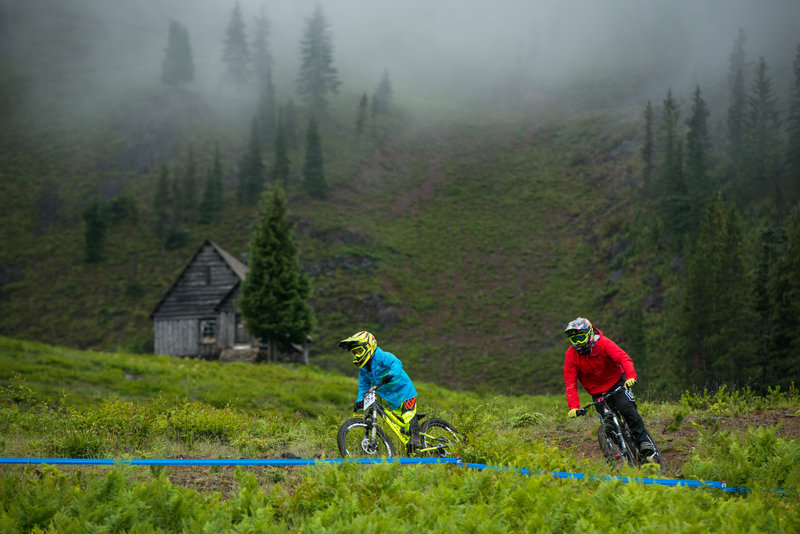 Riders descend below the Warming Hut on Gnar-Gnar on a raining morning.