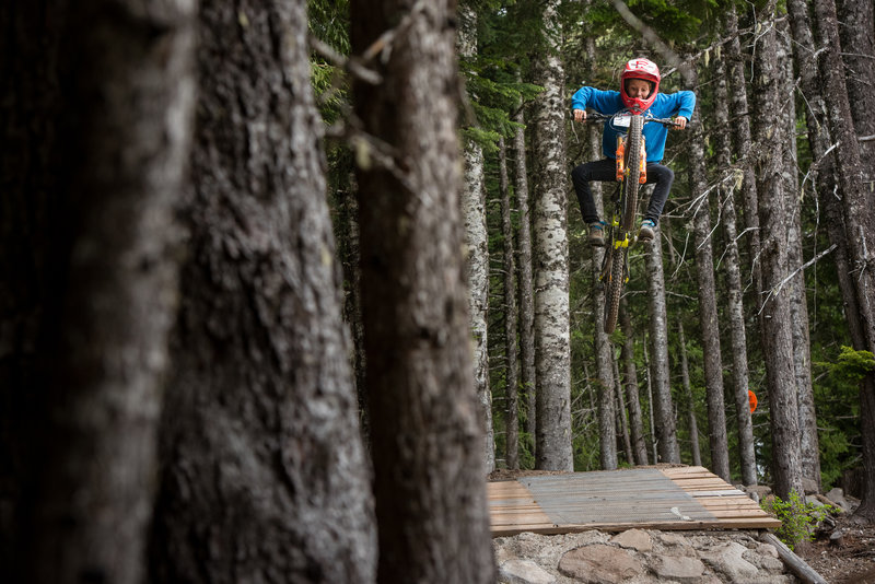 Jackson Goldstone pops high on the Skills Zone - Advanced Line at the base of the bike park.