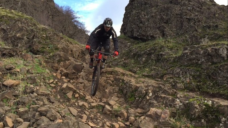 An insanely steep rock garden with a scree field runout.