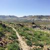 Looking out toward Pulpit And Kissing Rocks. The trail noticeably improves here, with fewer horse footprints and potholes.