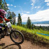 A racer cruises down Show-Low with a lake in the background.