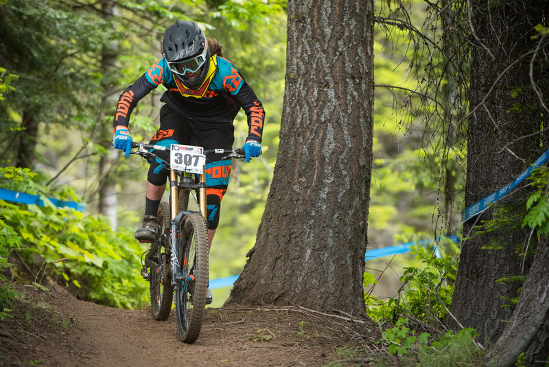 A racer puts the power down near the road crossing on Show-Low.