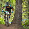 A racer puts the power down near the road crossing on Show-Low.