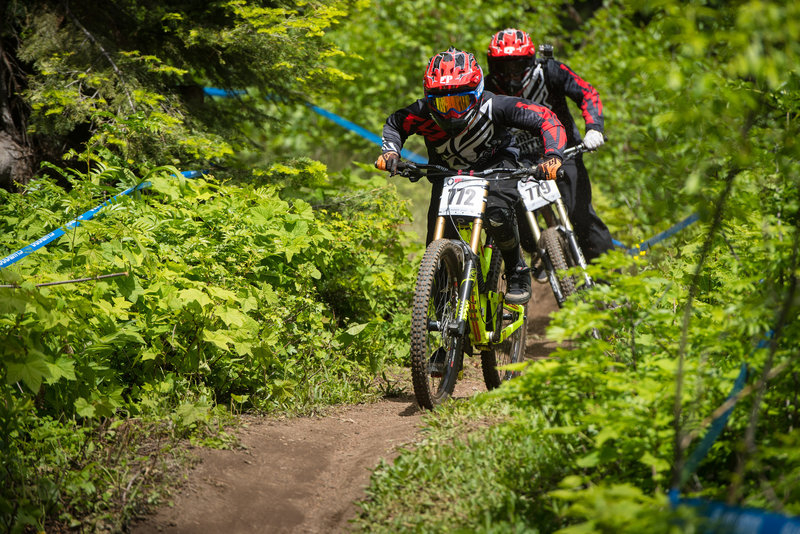 Racers pedal down a narrow ribbon of singletrack on Show-Low.