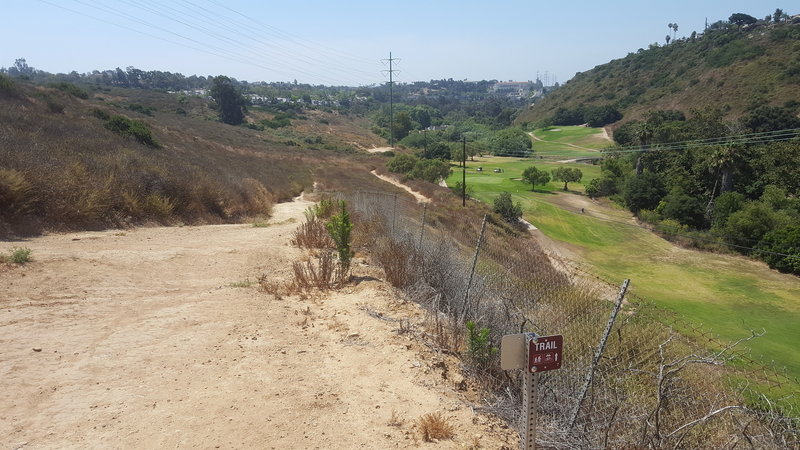 Great trail borders the fence near the golf course.