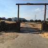 This is the gate at the top of the trail. It is locked. On the left, there is a narrow gap you can walk through and you have to lift your bike over your head to get through. Then start riding down the dirt road.