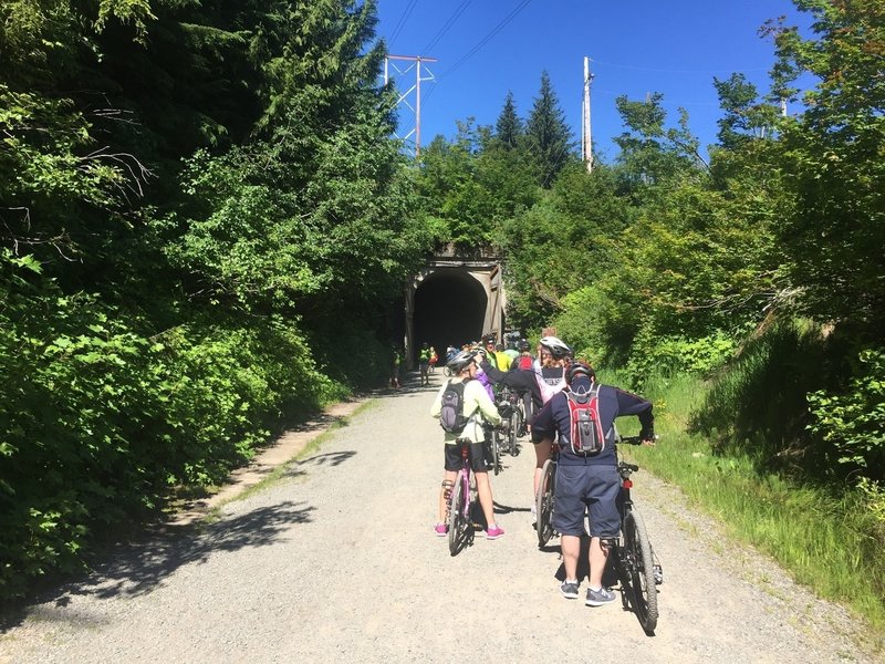 A large group ride prepares to enter the tunnel.  A unique, cold (~40F even when 80F outside), and very dark experience.  Good lights are a must!