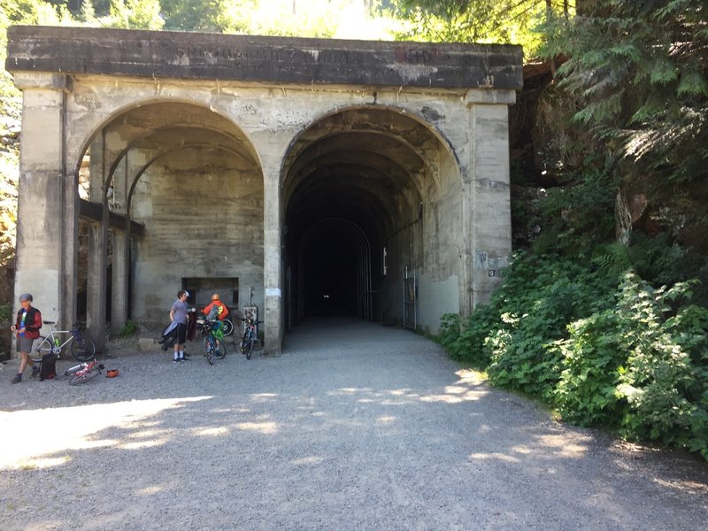 The exist of the Snoqualmie Tunnel.  A small cascading waterfall is off to the left.