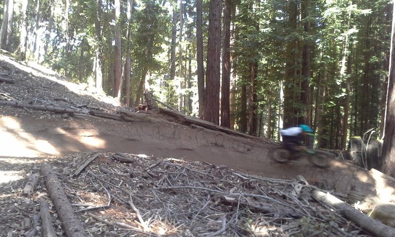 Tearin' thru a berm on the lower portion of the Flow Trail.