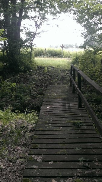 Wide bridge up to (or coming from) the large open fields