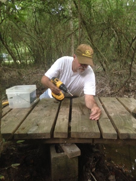 Johnny Hart repairs last board to reopen the Soggy Bottom bridge.  It was under 4-5' of water last week after we received over 12" of rain in 24 hours.