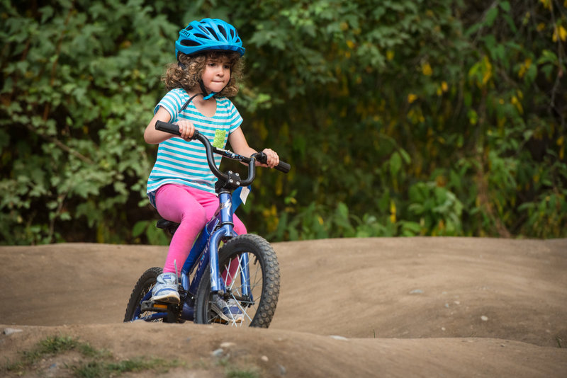 A young rider circles the "Grom" pumptrack at Whatcom Falls Park.