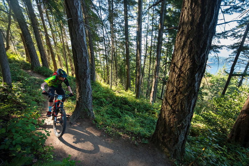 A racer rides past a glimpse out into the bay.