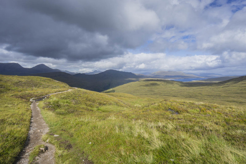 Singletrack leads down to Loch Leven from the top of the Devil's Staircase. Blackwater Reservoir to the right.