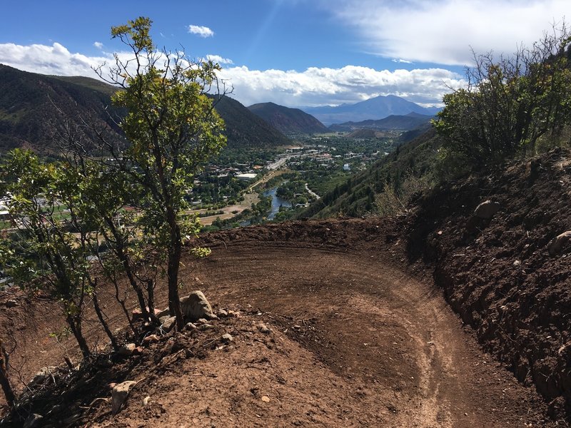 Fresh berm on lower middle Grandstaff Trail, with Roaring Fork River and Mount Sopris in the distance.