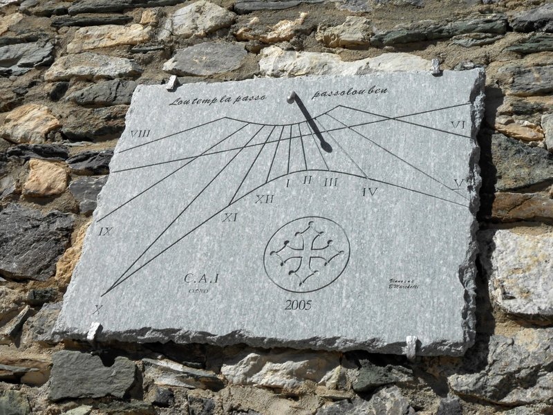 Sun dial at Rifugio Gardetta. In Occitan language, it reads "Time goes by. Pass it well"