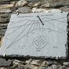 Sun dial at Rifugio Gardetta. In Occitan language, it reads "Time goes by. Pass it well"