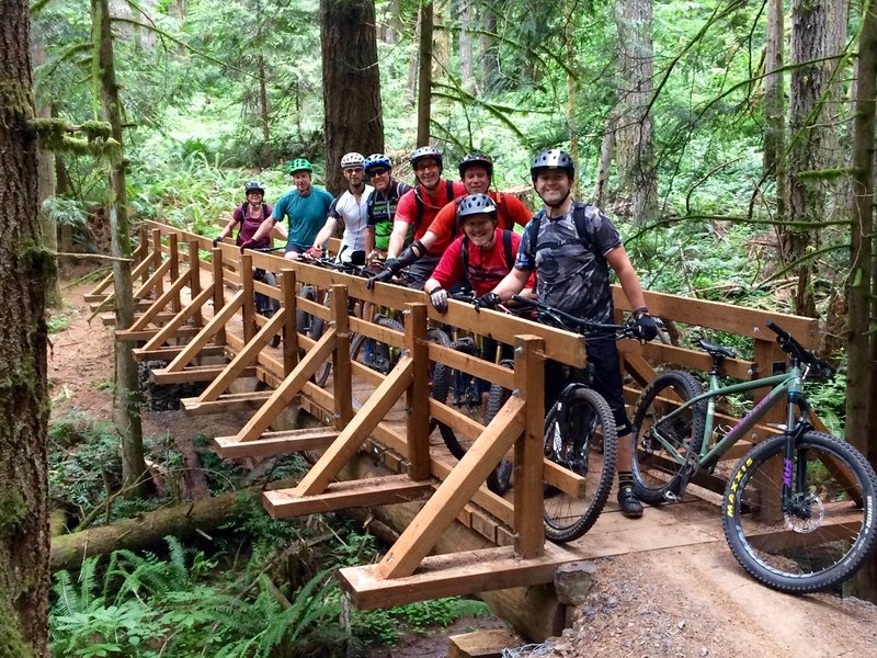 NW Trail Alliance ride group posing on the newly completed "Link'n'Pin" bridge on Shoofly over Genzer Creek