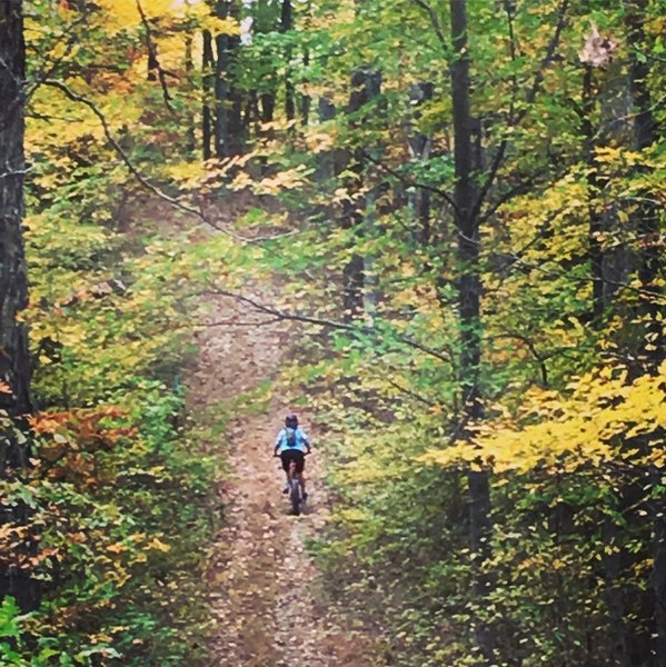 J. attacking hill on Lucas Hollow doubletrack