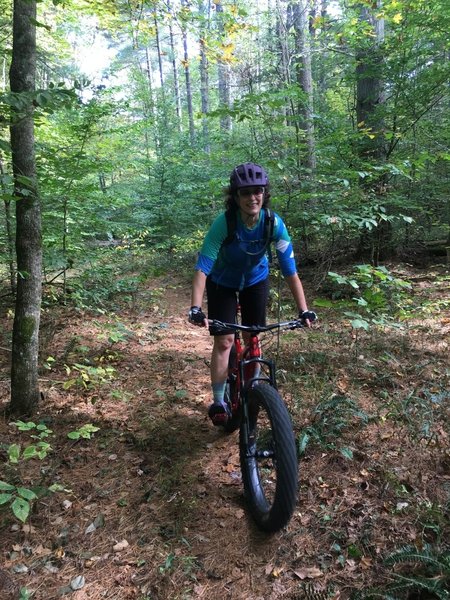 J. riding through the pine forest, the prettiest part of Lucas Hollow.