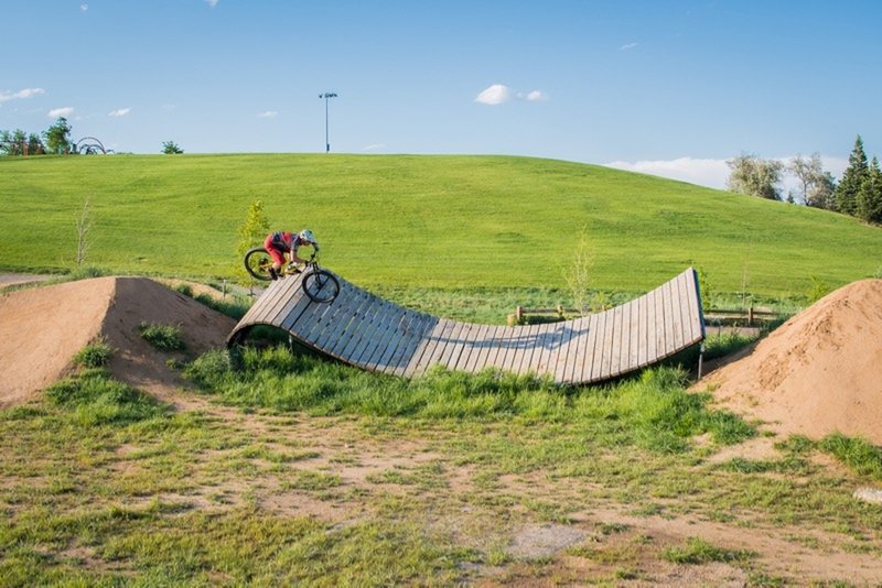 Jumping onto, and off of, a unique wooden feature on the XL Slopestyle Line.