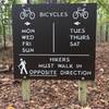 Sign shows which direction to ride or hike depending on the day of the week.