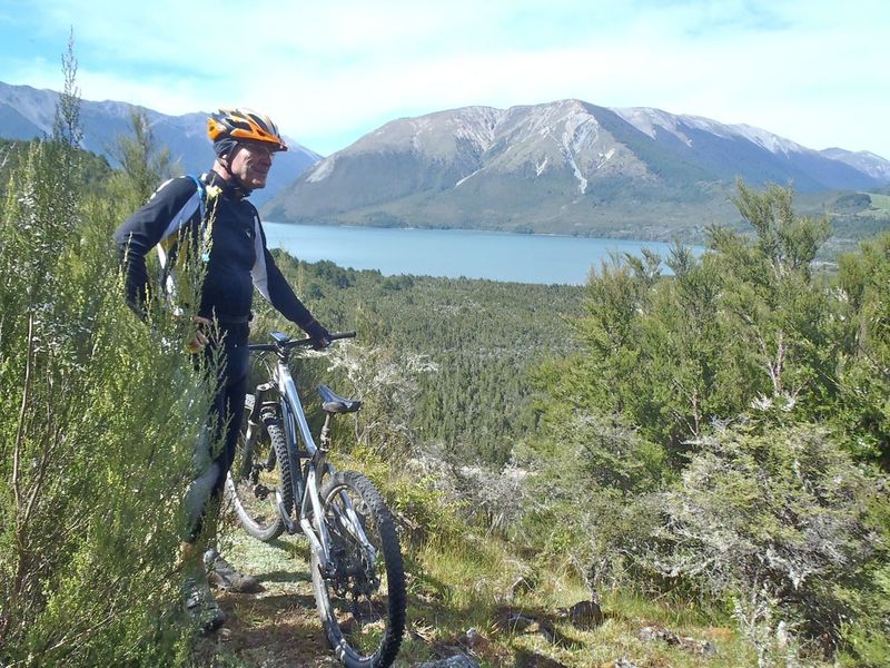 A rock outcrop offers a vista of Lake Rotoiti and Mt Robert