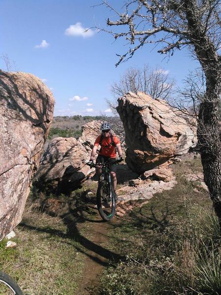 Riding through boulder of billion year old gneiss along the RPR Loop