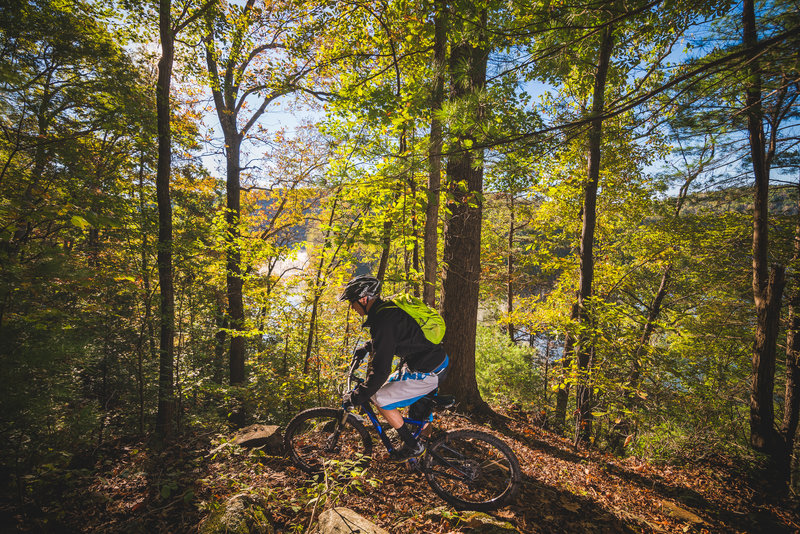 Tight singletrack and a sharp turn located on a steep rocky shoulder overlooks Philpott Lake down below.