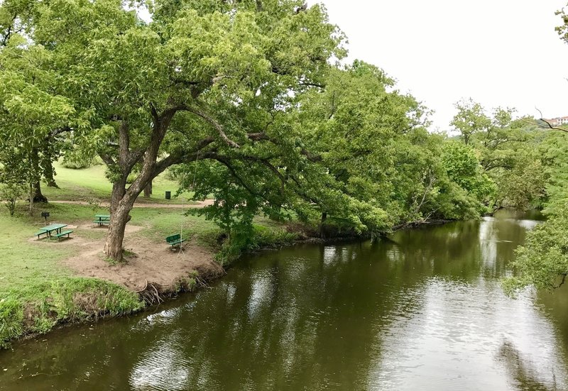 The trail winds along the shore of the creek with picnic benches and a rope swing  (make sure the water is up high enough before swinging out).