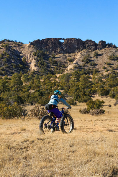 After a flowy descent through a Juniper forest along the Lemitas Trail the terrain opens up into a broad meadow beneath Window Rock