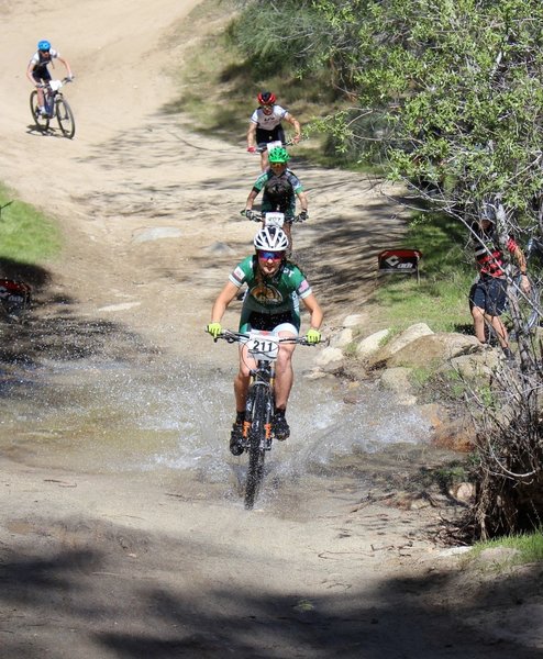 Varsity Girls making a big splash as they cross the creek!