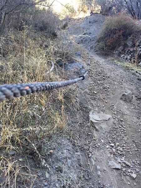 A rope for scrambling down and up the ravine.