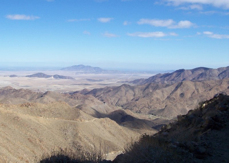 The flat area right after the mountain range is where you are heading.