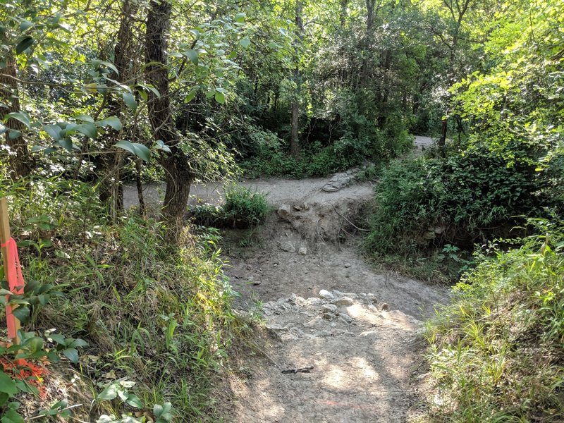 Watch out if you're coming pretty fast around the corner! There's no bridge here. You have to carry your bike and climb up and down this dry creek bed.