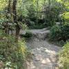 Watch out if you're coming pretty fast around the corner! There's no bridge here. You have to carry your bike and climb up and down this dry creek bed.