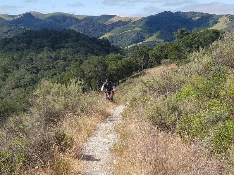 Friend riding up the trail to the high point of the Duna Vista Loop