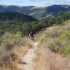 Friend riding up the trail to the high point of the Duna Vista Loop