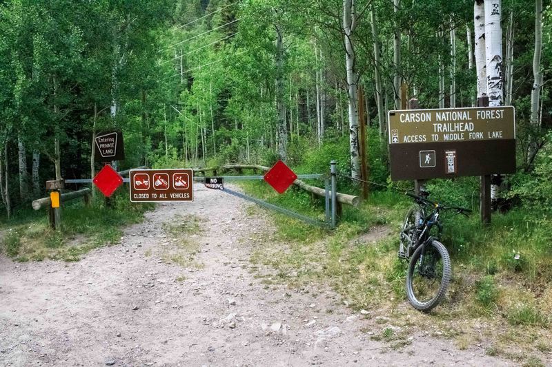 Middle Fork and Lost Lake trailhead. The first couple hundred feet crosses a public right of way across private property, don't be deterred by the gate ~ there is an entrance on the left for bikes and hikers.