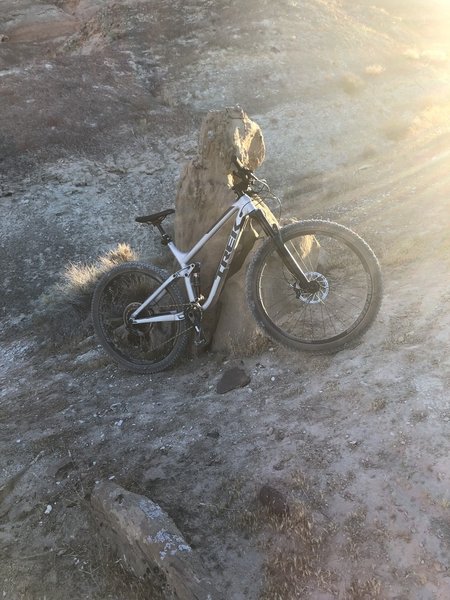Ride the trail when the sun comes up and look down from this rock at its shadow.