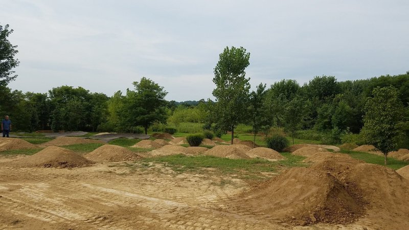 A progression of difficulty across the different jump lines. The paved pump track seen in the background of the picture is a great way to get warmed up before you send it on the jumps!