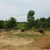 A progression of difficulty across the different jump lines. The paved pump track seen in the background of the picture is a great way to get warmed up before you send it on the jumps!