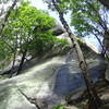 View of overhanging rock from trail below.