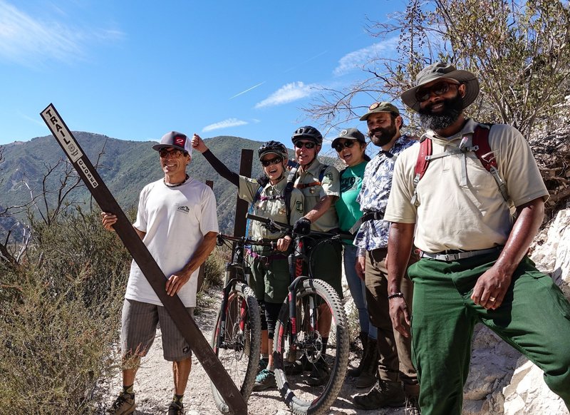 Steve Messer from CORBA removes the closed sign at Bear Canyon Junction on August 24, 2018. The trail is now open all the way through from Chantry to JPL, thank to CORBA, Mount Wilson Bicycling Association, REI and SCE.