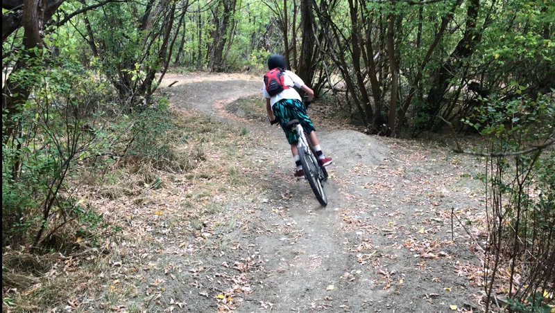 Cruising into the next berm on the Lower Coal Camp Descent.