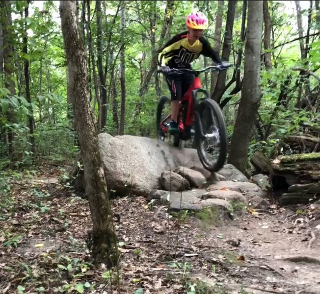 Riding one of the larger Rock pile features on this trail System!