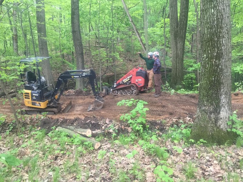 Machine operators from Spectrum Trail Designs, the builders of DTE Energy Foundation Trail, discussing the build line.