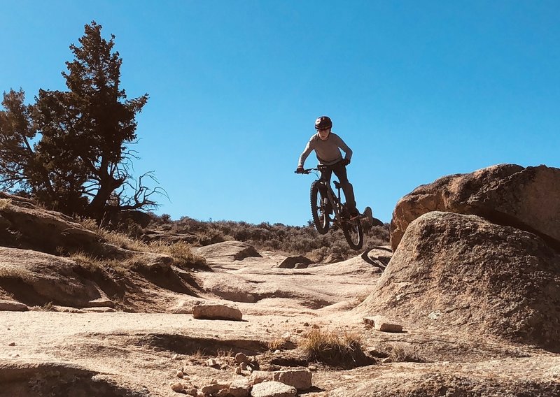 Enjoying the section “Behind the Rocks” playing on one of the many fun rocks on the side of the trail, unlimited number of optional lines you can make at this trail System on the slick rock!