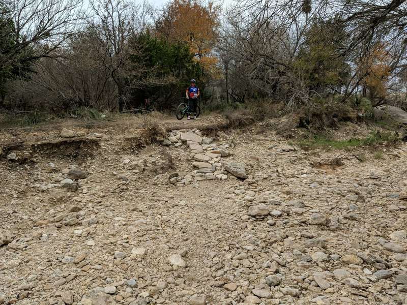 Creek crossing near golf course with rock armoring on the bank.