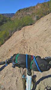 Sandy bank above dry wash